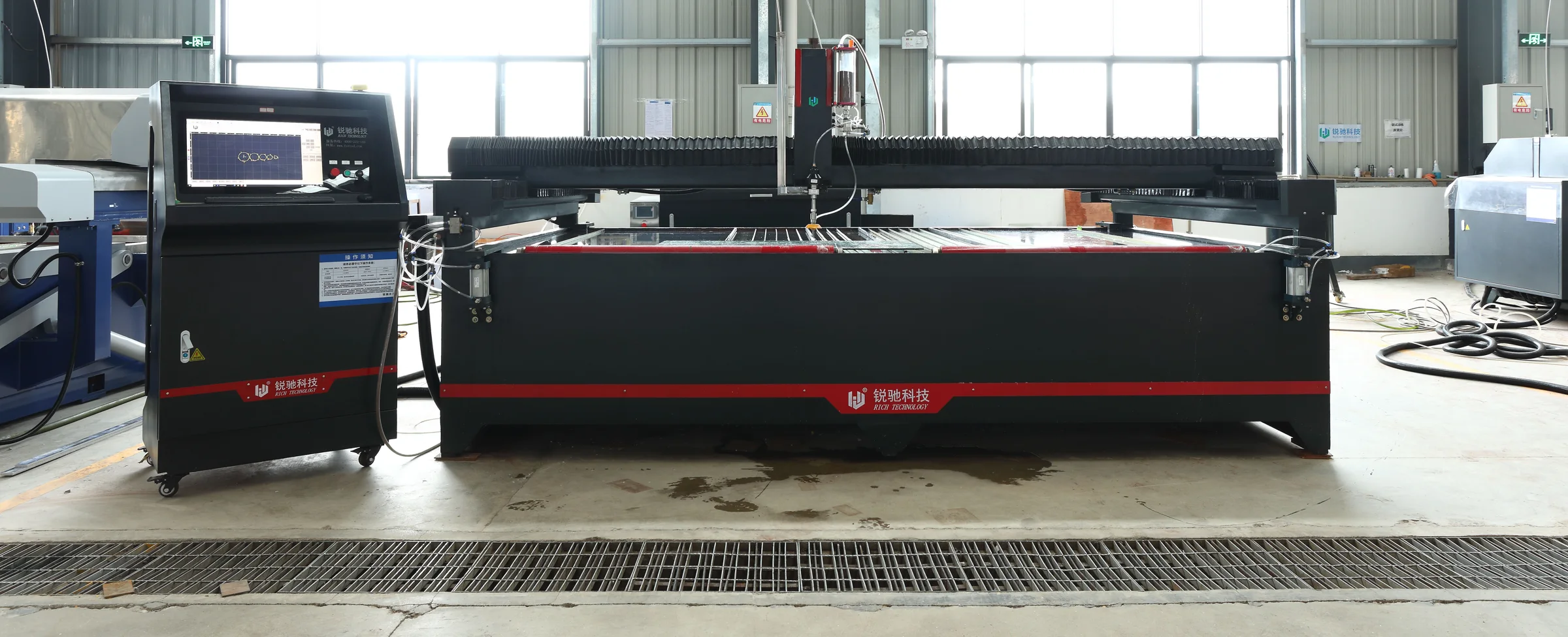 Rich 3-axis waterjet cutting table with CNC cabinet on the factory floor