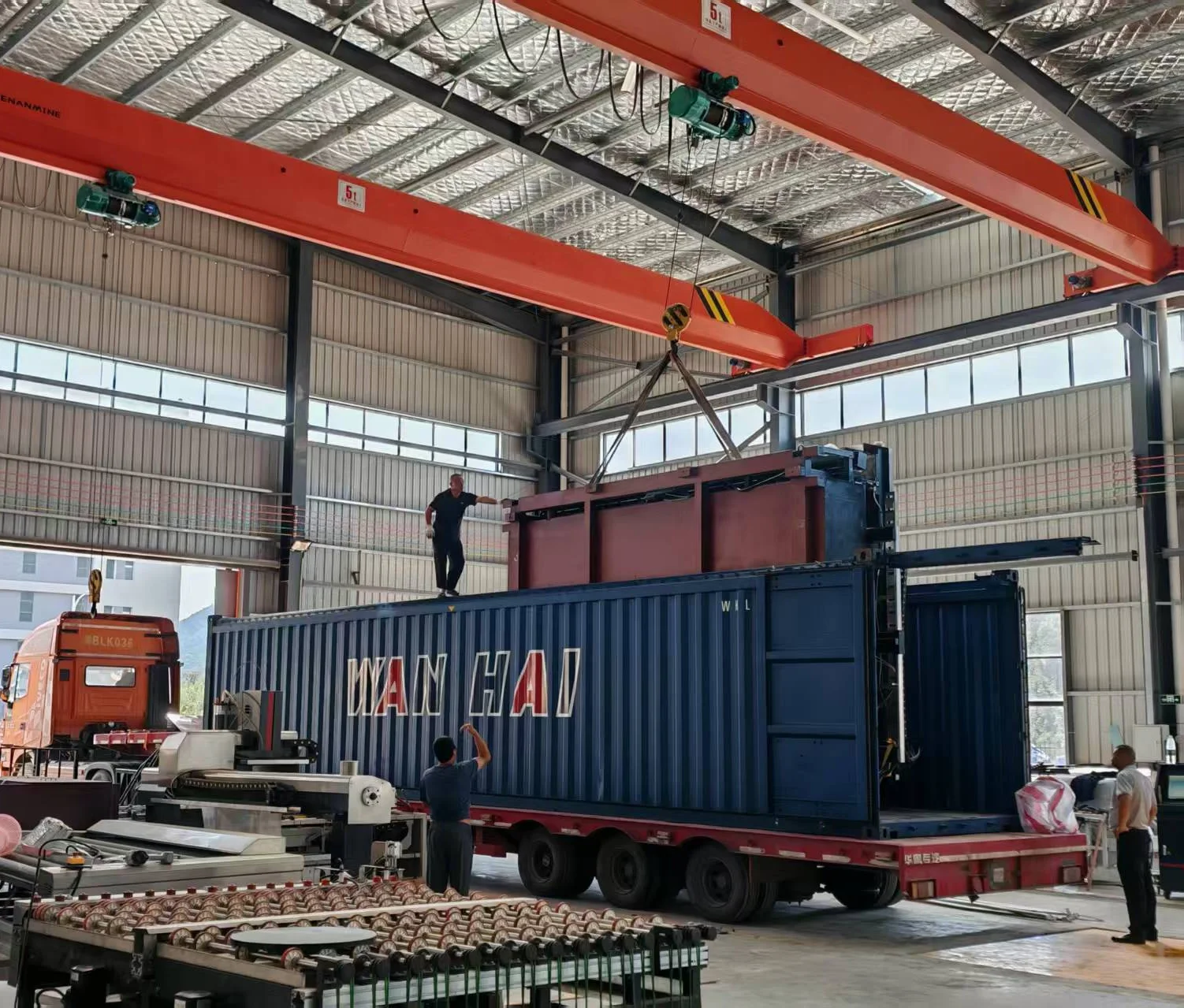 Container craned onto the truck at the Rich factory